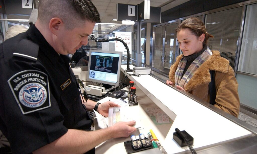 CBP officer reviewing reentry permit for permanent residents