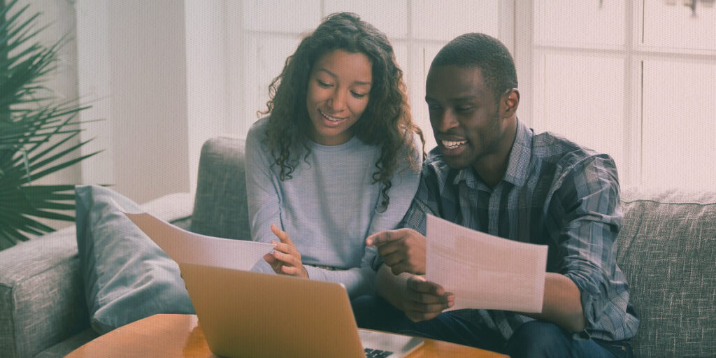 Couple on a computer prepares a spouse petition for a green card.