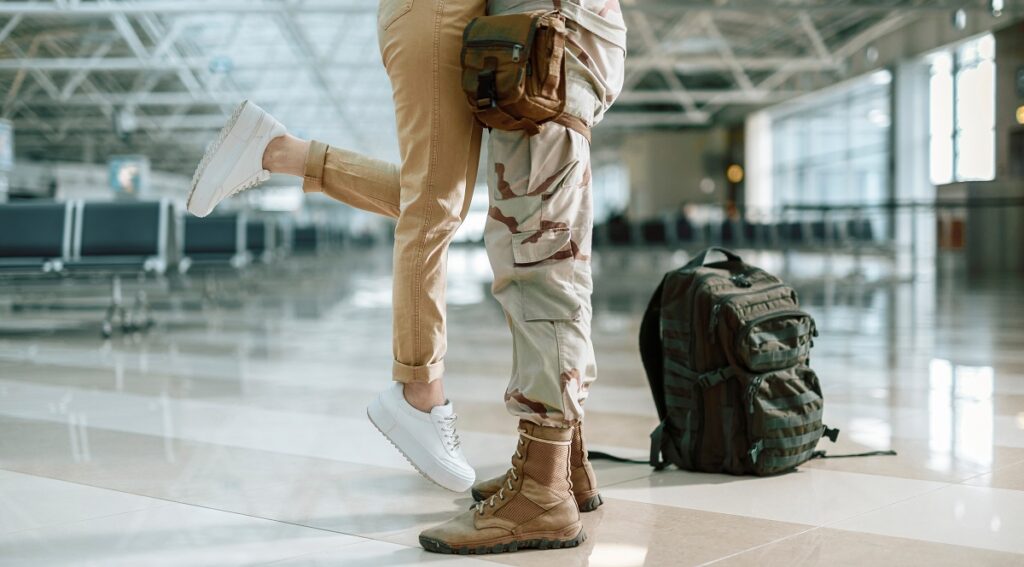 Military spouse with green card greets service member at airport