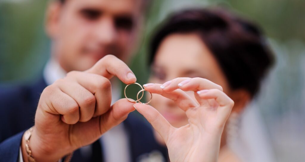 Couple display wedding rings after marriage