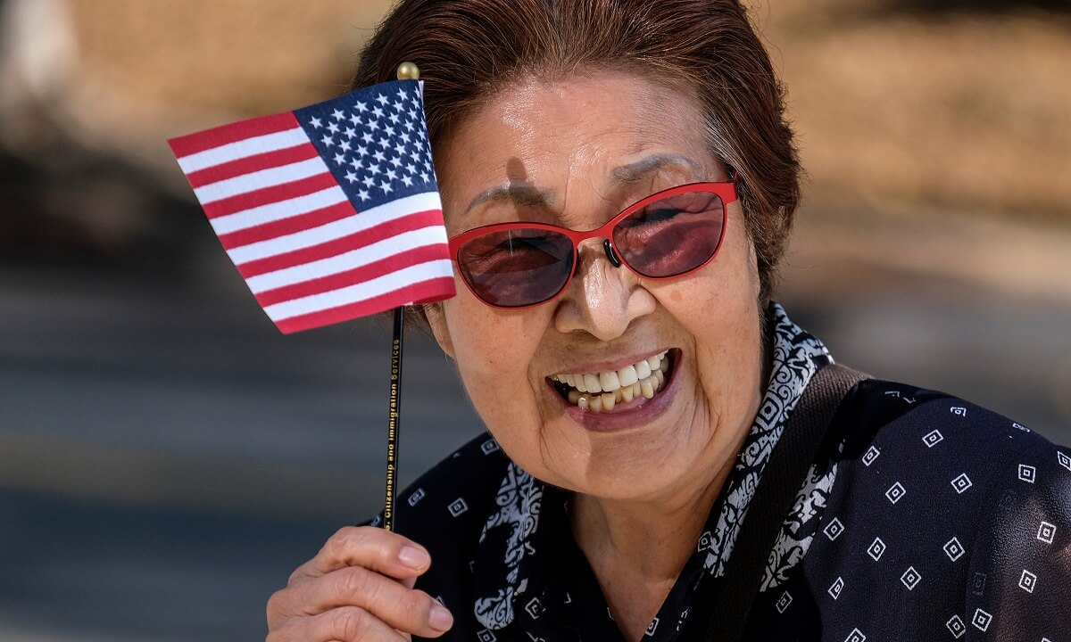 Woman enjoys the practical benefits of U.S. citizenship at a naturalization ceremony