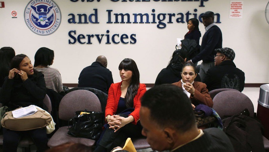 Woman waits for naturalization Interview inside a USCIS office