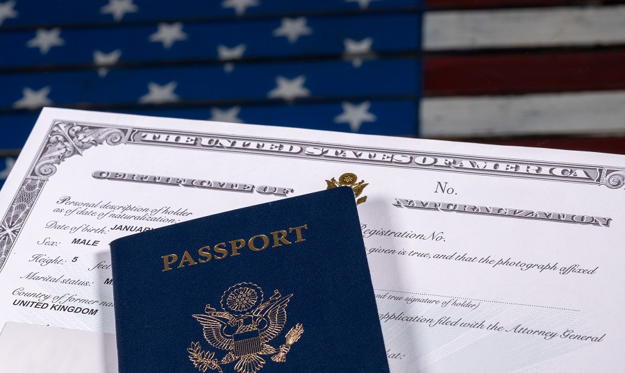 A U.S. passport sites on top of a naturalization certificate