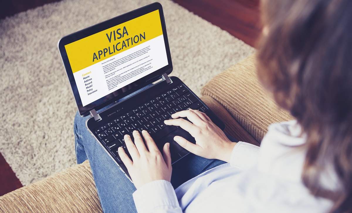 Woman works on visa waiver program application for ESTA travel