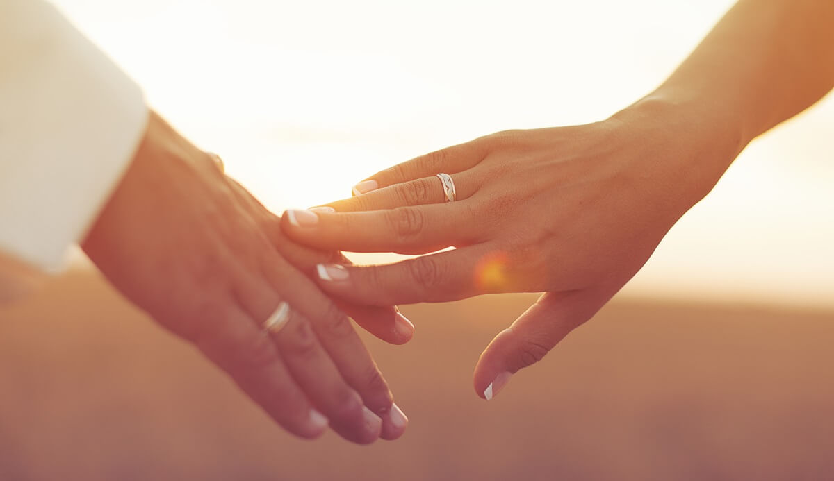 Newly engaged couple holding hands as US petitioner prepares to sponsor fiancé
